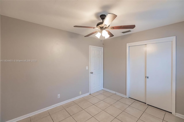 4423 Lake Ave, West Palm Beach, FL 33405 - unfurnished bedroom featuring a closet, a ceiling fan, and light tile patterned floors