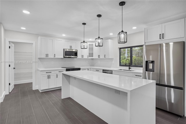 4879 NW 2nd Ct, Plantation, FL 33317 - kitchen with appliances with stainless steel finishes, backsplash, light countertops, white cabinetry, and recessed lighting