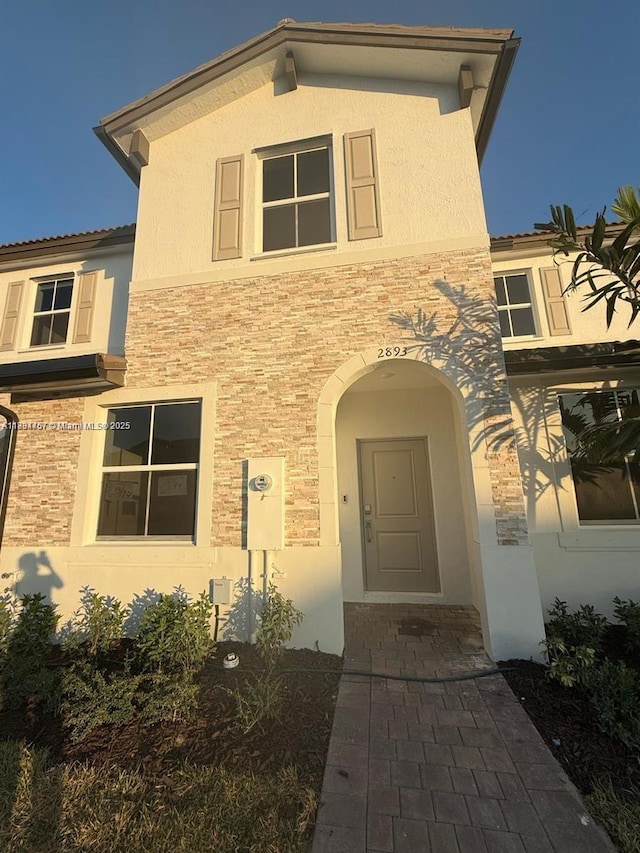 2893 SE 25th Rd Unit 2893, Homestead, FL 33035 - doorway to property with stucco siding and stone siding