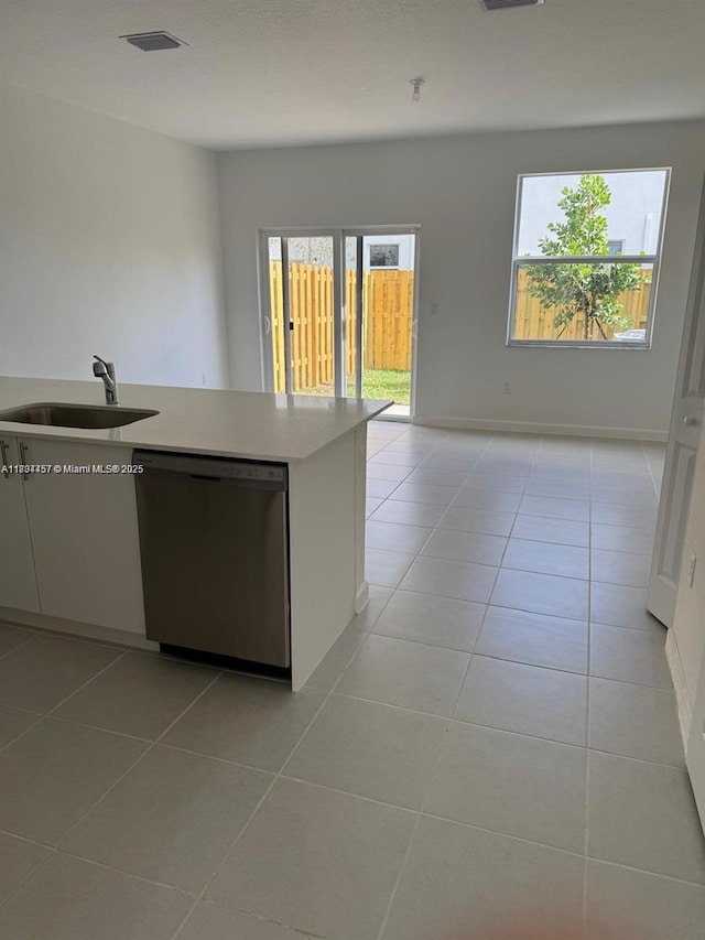 2893 SE 25th Rd Unit 2893, Homestead, FL 33035 - kitchen featuring stainless steel dishwasher, light tile patterned floors, light countertops, and open floor plan