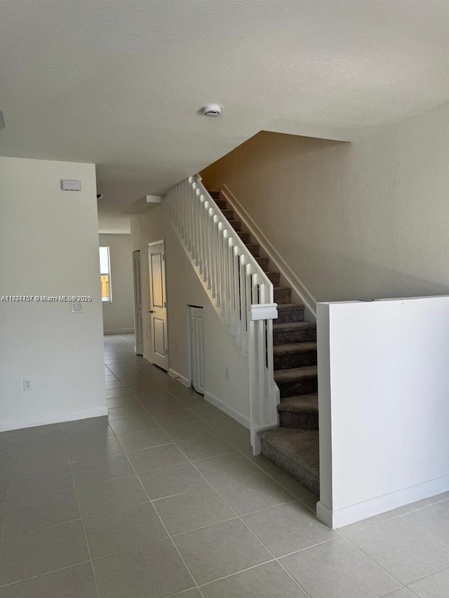 2893 SE 25th Rd Unit 2893, Homestead, FL 33035 - stairway with tile patterned floors and a textured ceiling