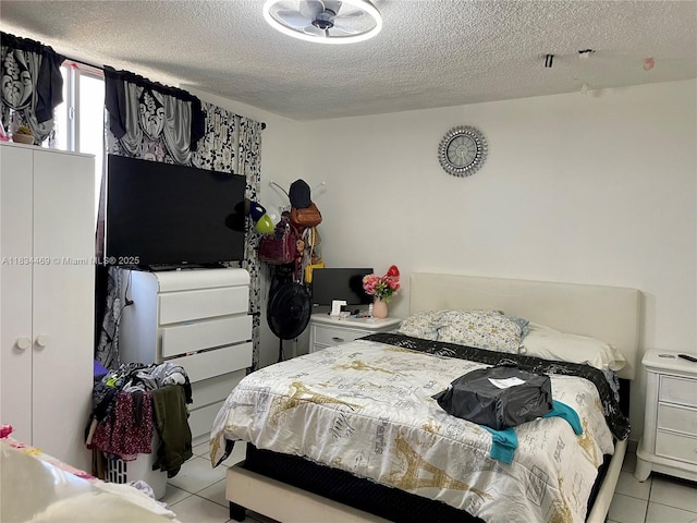 10090 NW 80th Ct Unit 1401, Hialeah Gardens, FL 33016 - bedroom featuring light tile patterned floors and a textured ceiling
