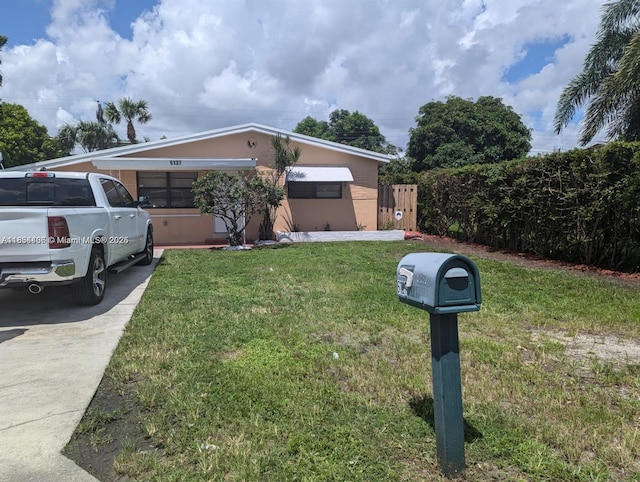 6137 Dewey St, Hollywood, FL 33023 - view of front of house featuring a front lawn and stucco siding