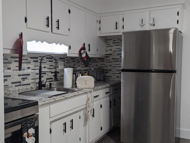 6137 Dewey St, Hollywood, FL 33023 - kitchen featuring stainless steel appliances, backsplash, and white cabinets