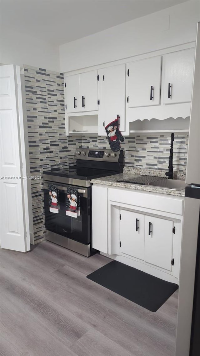 6137 Dewey St, Hollywood, FL 33023 - kitchen with appliances with stainless steel finishes, white cabinets, backsplash, wood finished floors, and light countertops
