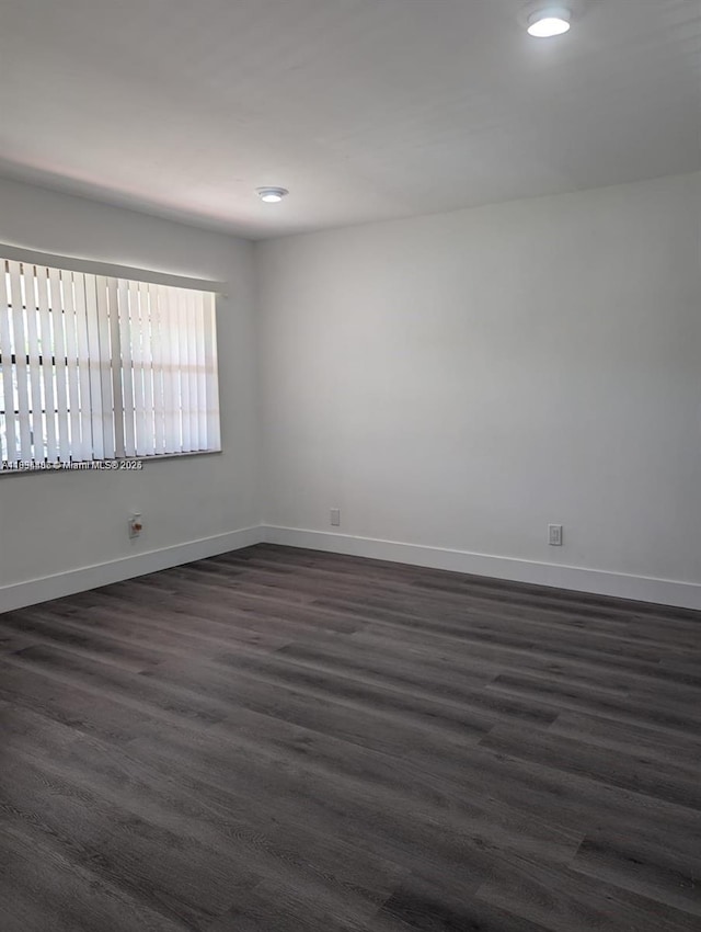 6137 Dewey St, Hollywood, FL 33023 - unfurnished room with dark wood-style floors and baseboards