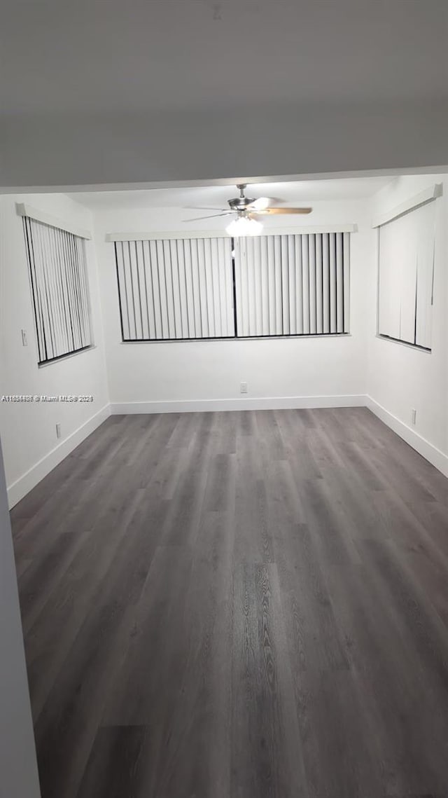 6137 Dewey St, Hollywood, FL 33023 - empty room with a ceiling fan and dark wood-type flooring