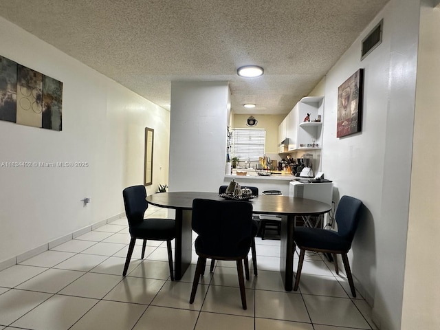 2775 W 52nd St Unit 305, Hialeah, FL 33016 - dining space featuring a textured ceiling and light tile patterned floors