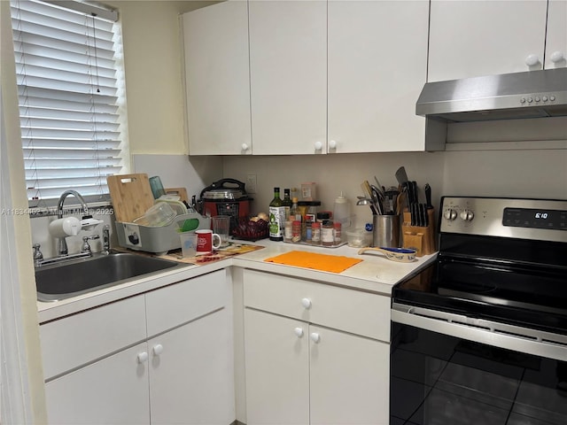 2775 W 52nd St Unit 305, Hialeah, FL 33016 - kitchen with electric stove, wall chimney exhaust hood, white cabinets, and light countertops
