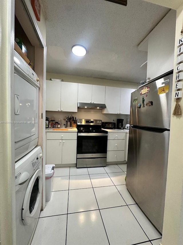 2775 W 52nd St Unit 305, Hialeah, FL 33016 - kitchen featuring appliances with stainless steel finishes, estacked washer and dryer, under cabinet range hood, white cabinetry, and a textured ceiling