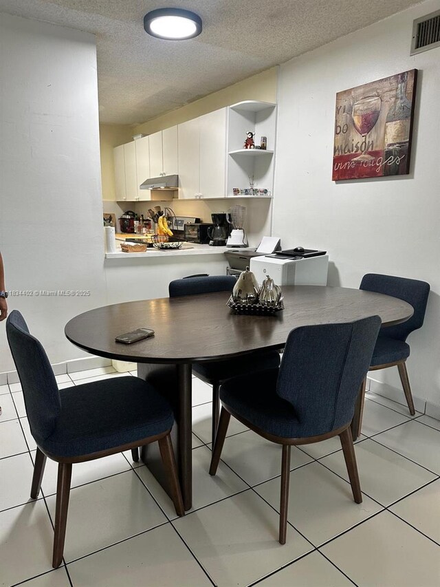 2775 W 52nd St Unit 305, Hialeah, FL 33016 - dining area featuring light tile patterned floors and a textured ceiling