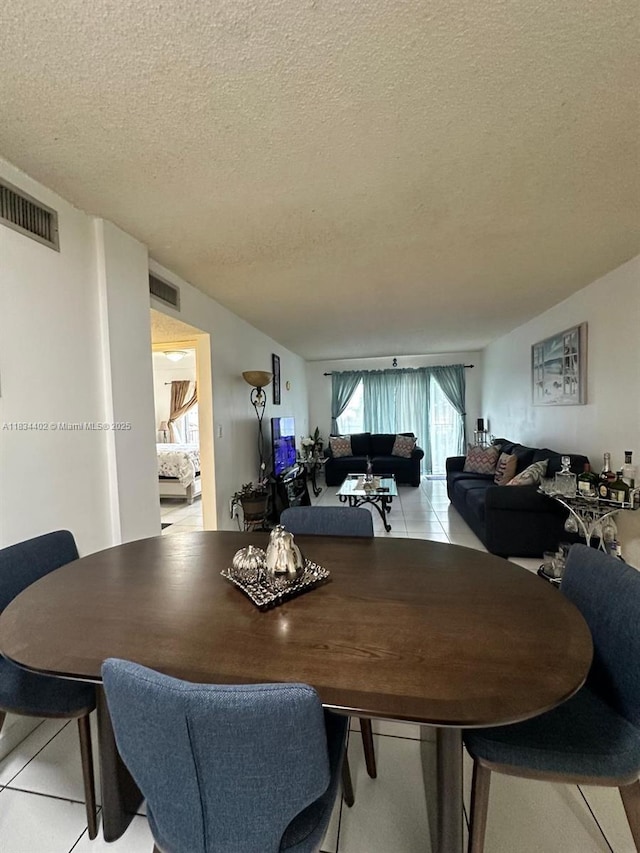 2775 W 52nd St Unit 305, Hialeah, FL 33016 - dining space with a textured ceiling