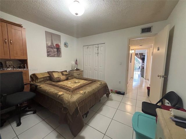2775 W 52nd St Unit 305, Hialeah, FL 33016 - bedroom with a textured ceiling, light tile patterned floors, and a closet