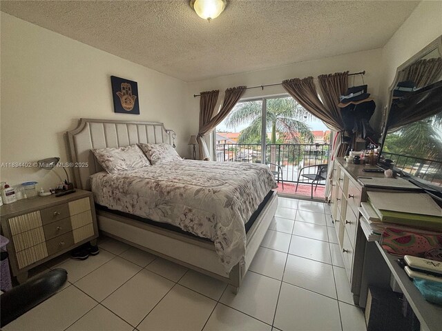 2775 W 52nd St Unit 305, Hialeah, FL 33016 - bedroom featuring access to outside, a textured ceiling, and light tile patterned flooring