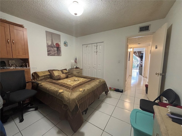 2775 W 52nd St Unit 305, Hialeah, FL 33016 - bedroom with a textured ceiling, light tile patterned flooring, and a closet