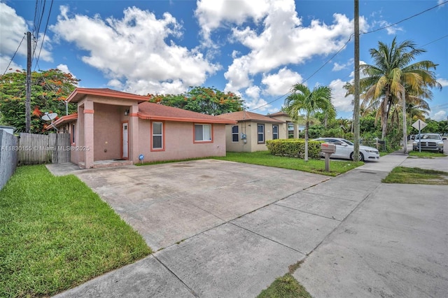2175 NW 50th St, Miami, FL 33142 - view of front facade featuring stucco siding and concrete driveway