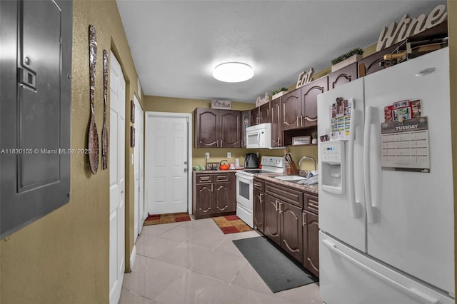 2175 NW 50th St, Miami, FL 33142 - kitchen featuring white appliances, dark brown cabinets, light tile patterned floors, a textured ceiling, and light countertops