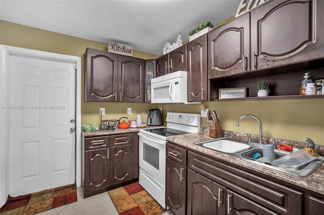 2175 NW 50th St, Miami, FL 33142 - kitchen featuring white appliances, dark brown cabinetry, open shelves, tile patterned flooring, and light countertops