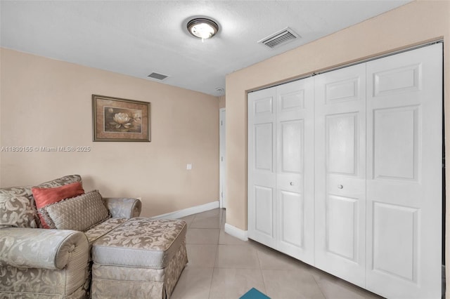 2175 NW 50th St, Miami, FL 33142 - sitting room with light tile patterned floors and a textured ceiling