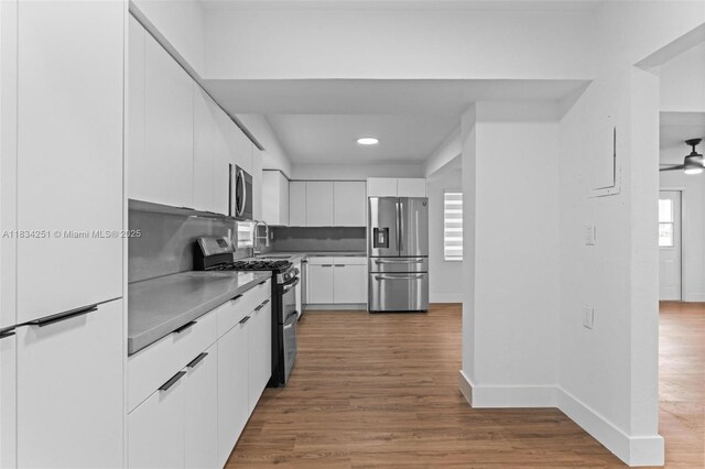 20620 Anchor Rd, Cutler Bay, FL 33189 - kitchen featuring stainless steel appliances, white cabinetry, wood finished floors, recessed lighting, and modern cabinets