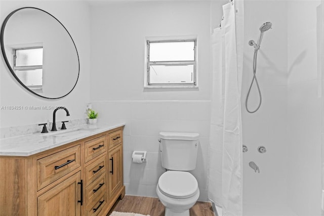 20620 Anchor Rd, Cutler Bay, FL 33189 - full bath featuring vanity, tile walls, a shower with shower curtain, wainscoting, and wood finished floors