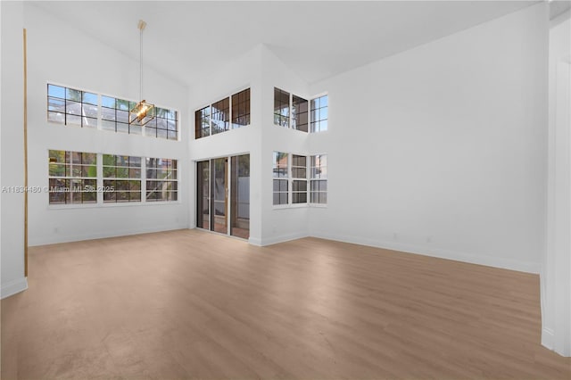 1525 Seabay Rd, Weston, FL 33326 - empty room featuring wood finished floors, a high ceiling, and a chandelier