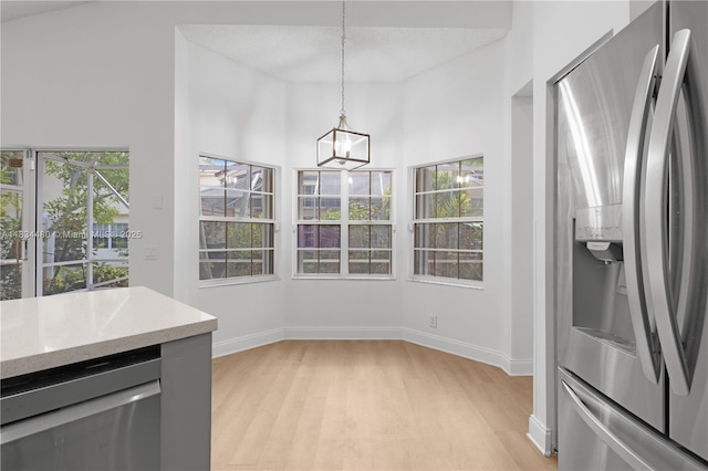 1525 Seabay Rd, Weston, FL 33326 - unfurnished dining area featuring light wood-style floors and a chandelier