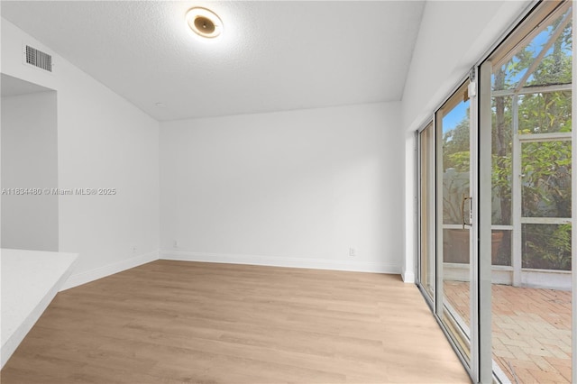 1525 Seabay Rd, Weston, FL 33326 - spare room featuring light wood-style flooring and a textured ceiling