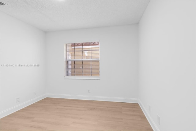 1525 Seabay Rd, Weston, FL 33326 - unfurnished room featuring light wood-type flooring and a textured ceiling