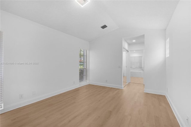 1525 Seabay Rd, Weston, FL 33326 - spare room with light wood finished floors and vaulted ceiling
