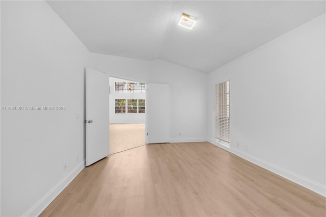 1525 Seabay Rd, Weston, FL 33326 - spare room featuring light wood-style floors and vaulted ceiling