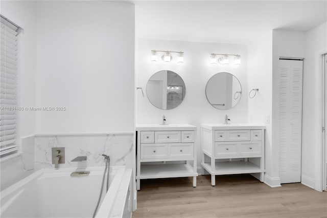 1525 Seabay Rd, Weston, FL 33326 - full bath with a closet, vanity, a garden tub, and wood finished floors