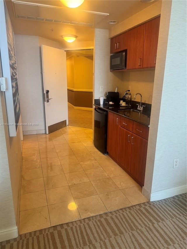 18001 Collins Ave Unit 1810, Sunny Isles Beach, FL 33160 - kitchen with dishwashing machine, dark countertops, and black microwave