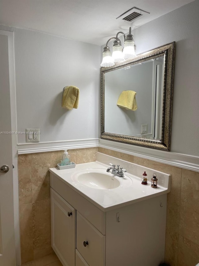 3180 S Ocean Dr Unit 1602, Hallandale Beach, FL 33009 - bathroom with vanity, tile walls, and a wainscoted wall