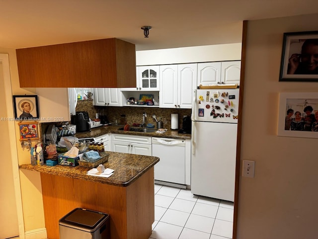9156 Collins Ave Unit 310, Surfside, FL 33154 - kitchen featuring white appliances, a peninsula, white cabinetry, decorative backsplash, and light tile patterned floors