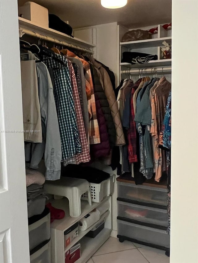 9156 Collins Ave Unit 310, Surfside, FL 33154 - walk in closet featuring tile patterned flooring