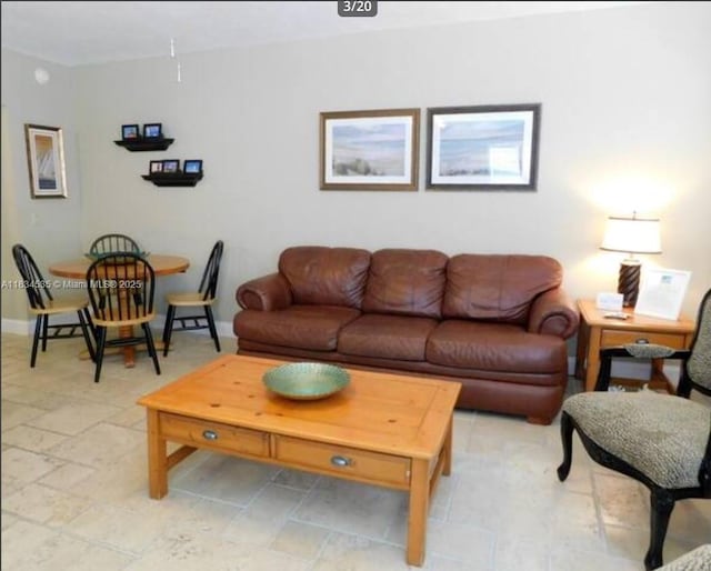 310 Arthur St Unit 9, Hollywood, FL 33019 - living room with baseboards and light stone finish floors