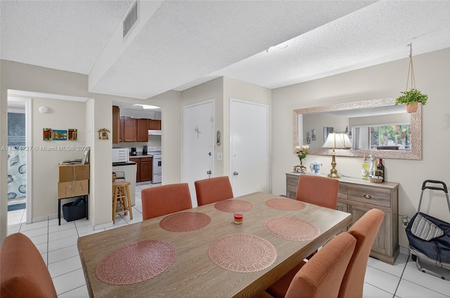7745 SW 86th St Unit D-222, Miami, FL 33143 - dining space with light tile patterned flooring and a textured ceiling