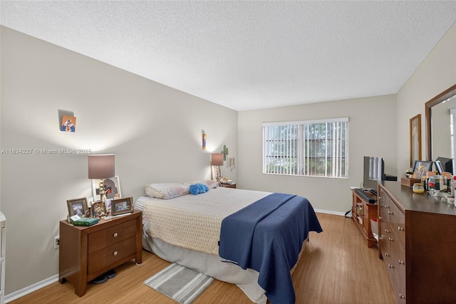 7745 SW 86th St Unit D-222, Miami, FL 33143 - bedroom with light wood-style flooring and a textured ceiling