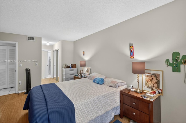 7745 SW 86th St Unit D-222, Miami, FL 33143 - bedroom featuring wood finished floors and a textured ceiling