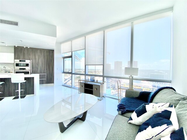 851 NE 1st Ave Unit 2802, Miami, FL 33132 - living area with expansive windows and light tile patterned flooring