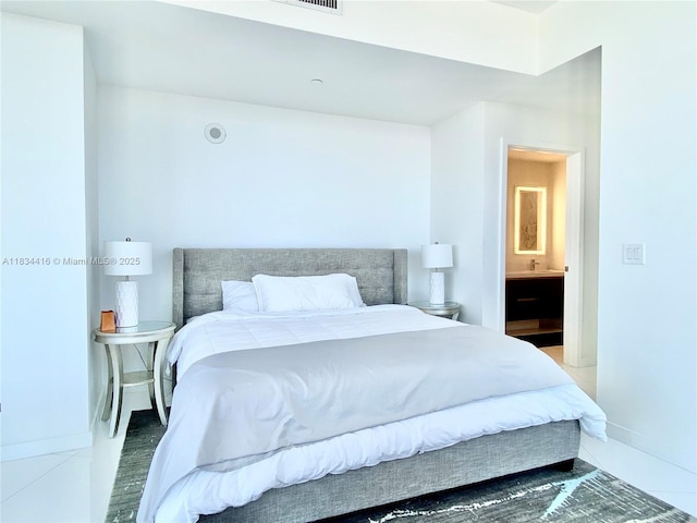 851 NE 1st Ave Unit 2802, Miami, FL 33132 - bedroom featuring baseboards and connected bathroom