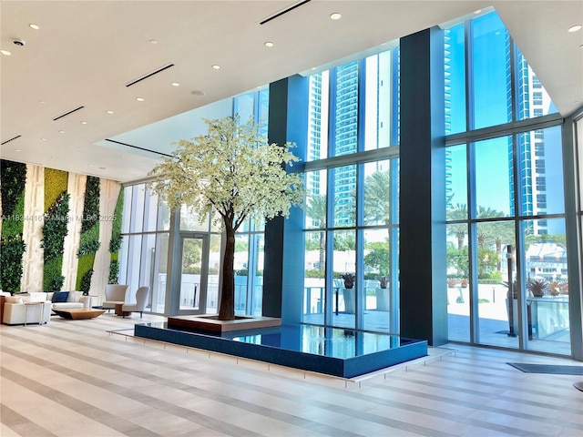 851 NE 1st Ave Unit 2802, Miami, FL 33132 - lobby with a wall of windows, a towering ceiling, and recessed lighting