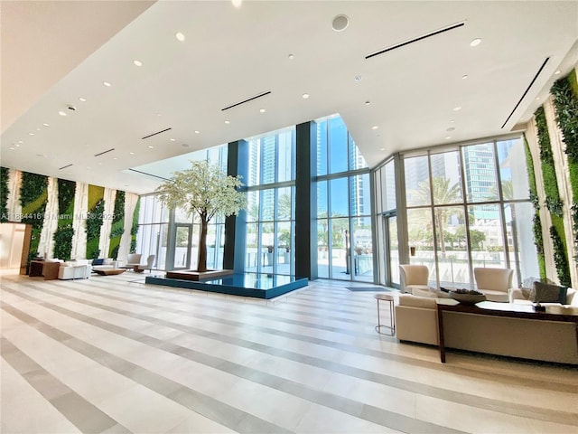 851 NE 1st Ave Unit 2802, Miami, FL 33132 - community lobby with expansive windows, a towering ceiling, and recessed lighting