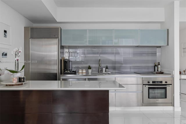 1040 Biscayne Blvd Unit 2108, Miami, FL 33132 - kitchen featuring appliances with stainless steel finishes, backsplash, modern cabinets, and light countertops