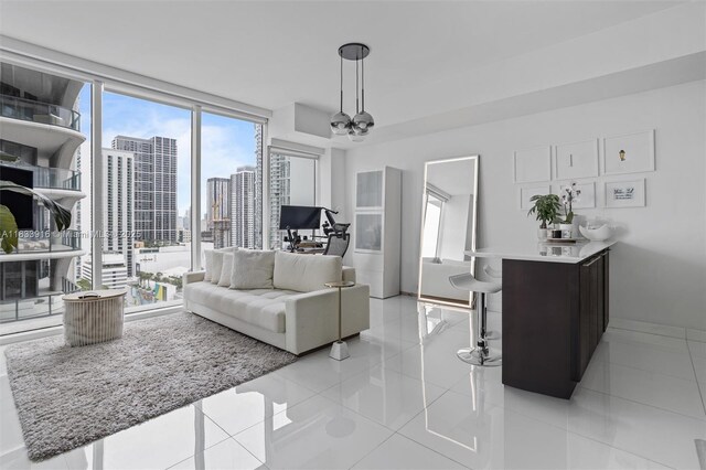 1040 Biscayne Blvd Unit 2108, Miami, FL 33132 - living area with a city view, light tile patterned floors, a chandelier, expansive windows, and an office area