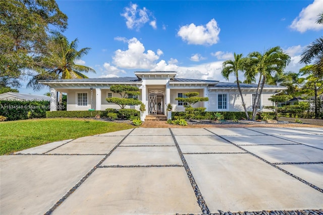 16701 SW 49th St, Southwest Ranches, FL 33331 - view of front of property featuring a front yard, covered porch, and a metal roof