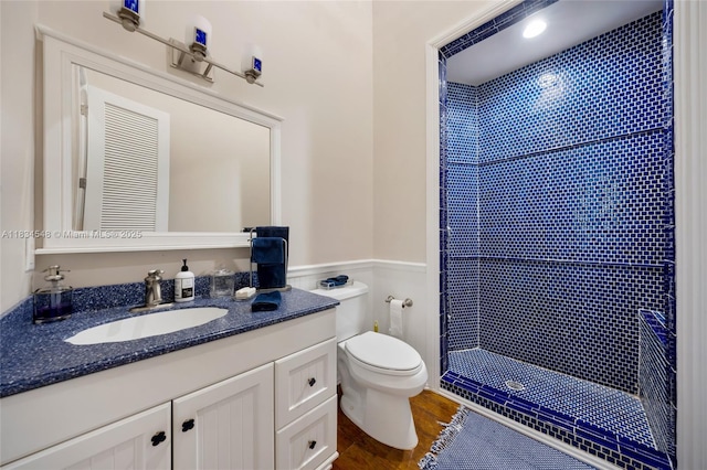 16701 SW 49th St, Southwest Ranches, FL 33331 - full bath with a tile shower, vanity, wood finished floors, and a wainscoted wall