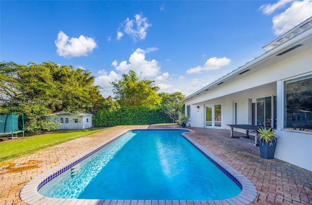 16701 SW 49th St, Southwest Ranches, FL 33331 - view of swimming pool with a trampoline, a patio, and an outdoor structure
