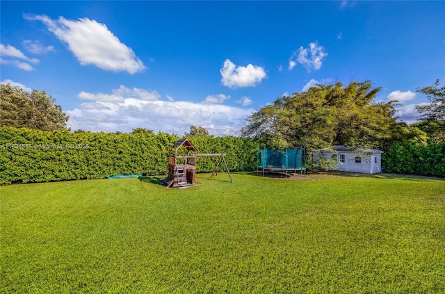 16701 SW 49th St, Southwest Ranches, FL 33331 - view of grassy yard with a trampoline, a playground, and an outbuilding